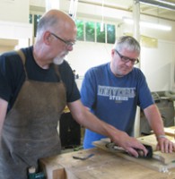 Chris Instructing student in woodwork.